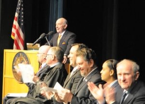 President Daniel M. Asquino on stage speaking behind the podium