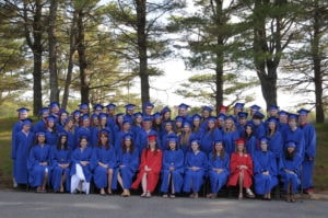 Group of dual enrollment graduates in their caps and gowns