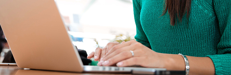 Woman Typing on Laptop