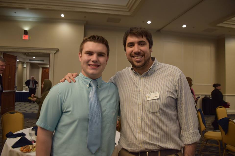 Aidan Provost and program director Evan Berry at an event