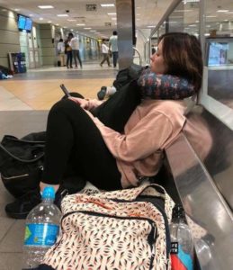 Adrienne sitting on the airport floor