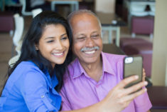 Father and college aged daughter taking a selfie