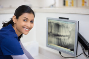 Photo of a dental hygiene student looking at Xrays