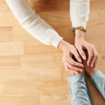 Photo of two people holding hands