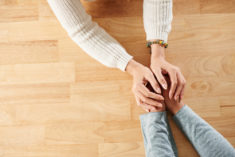 Photo of two people holding hands