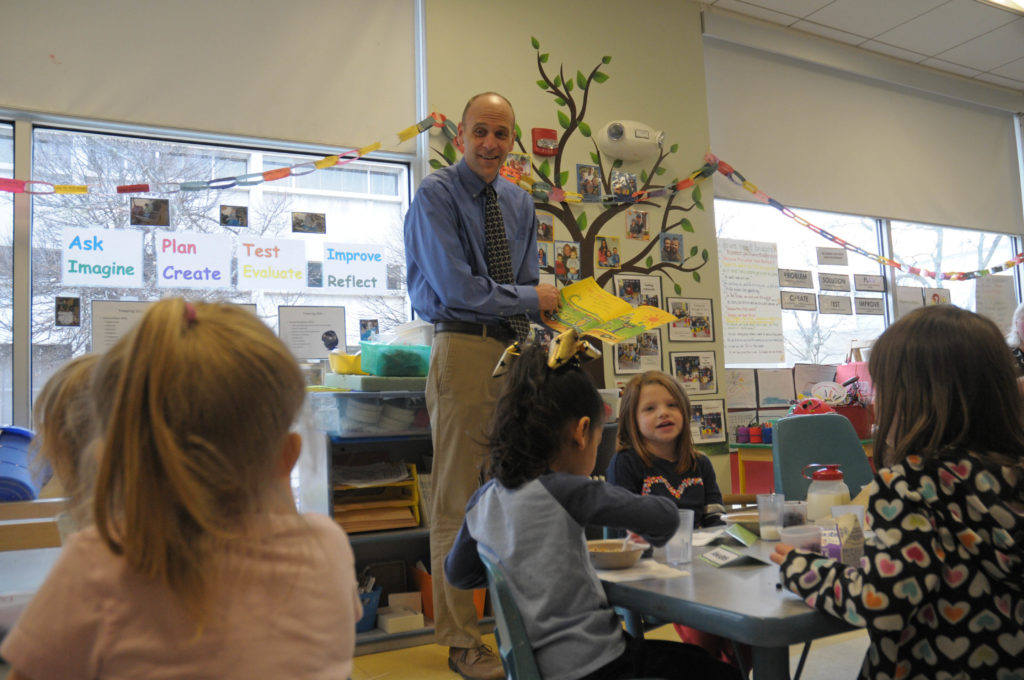 A man reads to children.