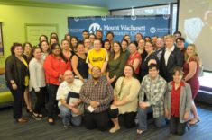 A group of around 40 people pose for a photo.