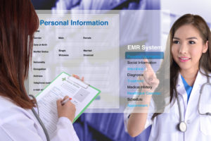 hand touching display of electronic medical record