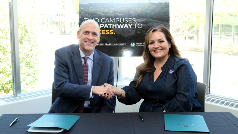 President Jim Vander Hooven and President Donna Hodge sign housing agreement
