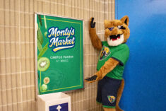 MWCC Montys Market sign with Monty showing it off