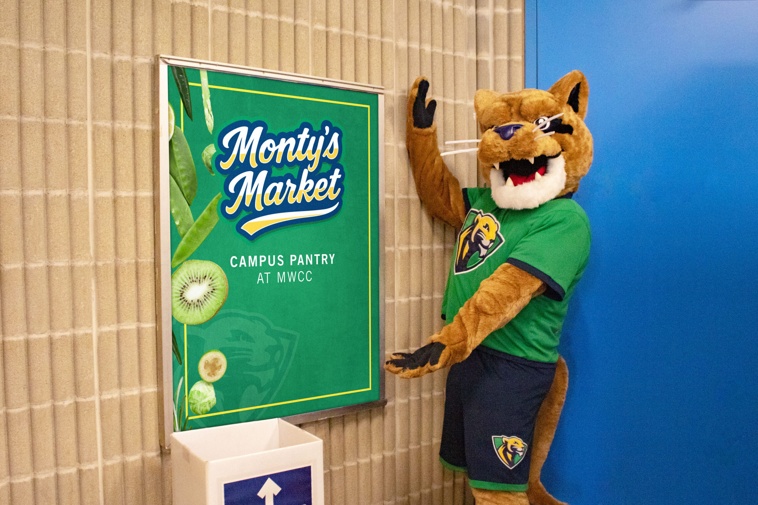 MWCC Montys Market sign with Monty showing it off