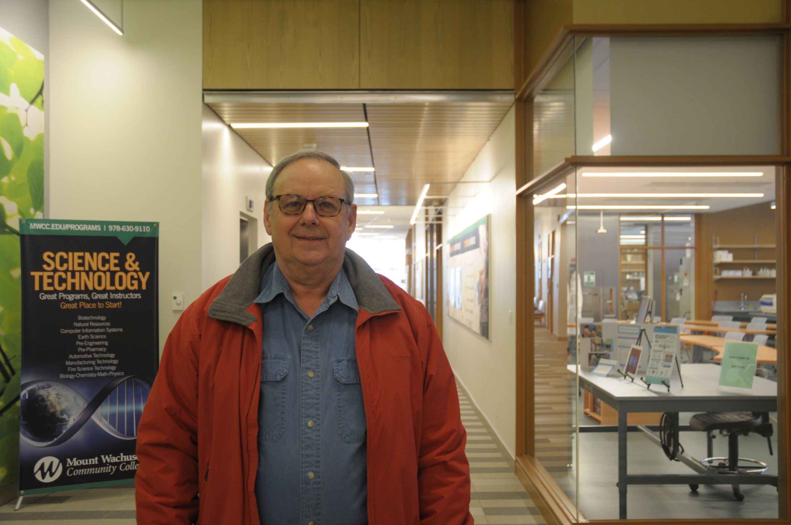 Armand Savoie stands in the hallway of the college's science building.