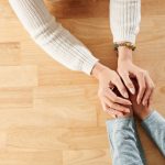 Photo of two people holding hands
