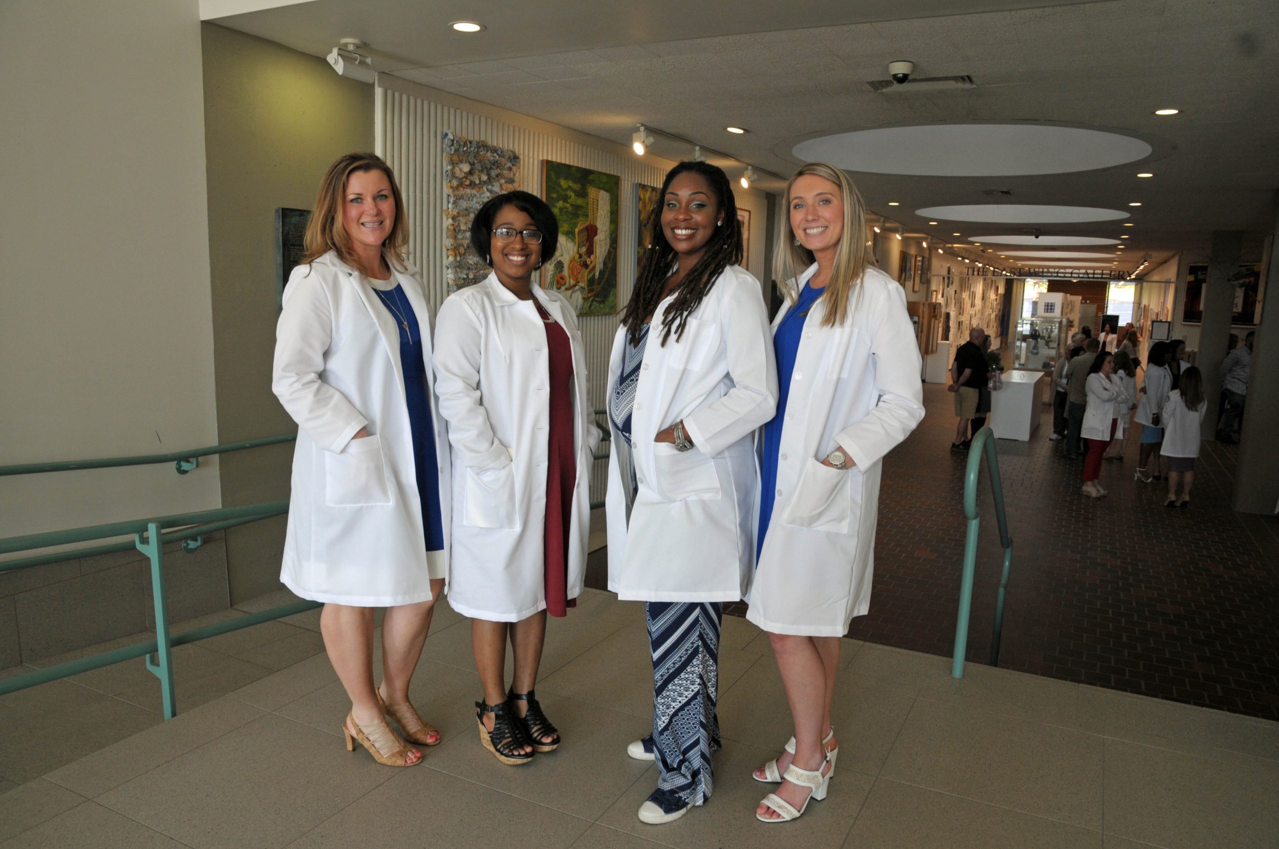 four women stand in a row