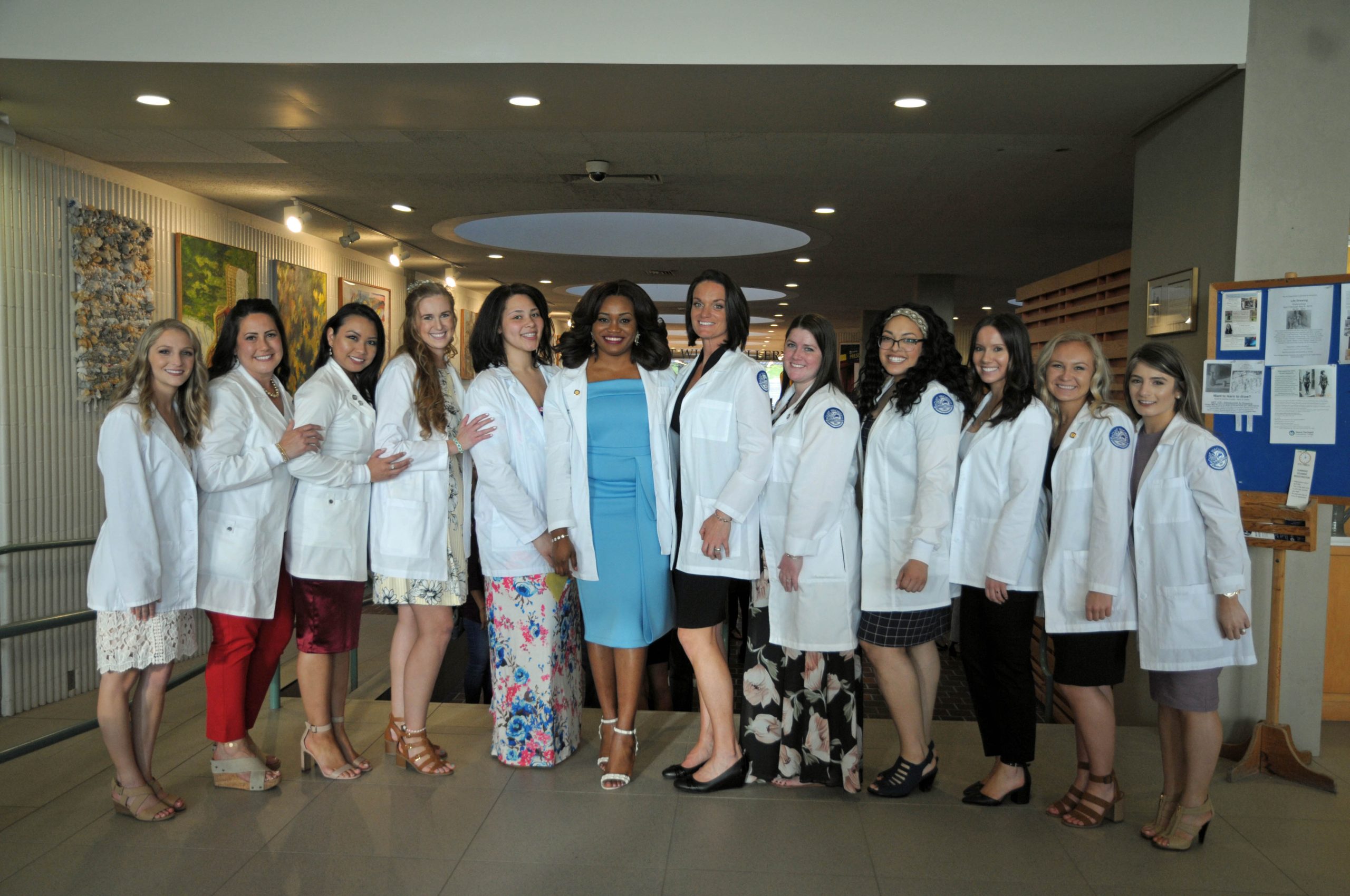 12 women stand in a row