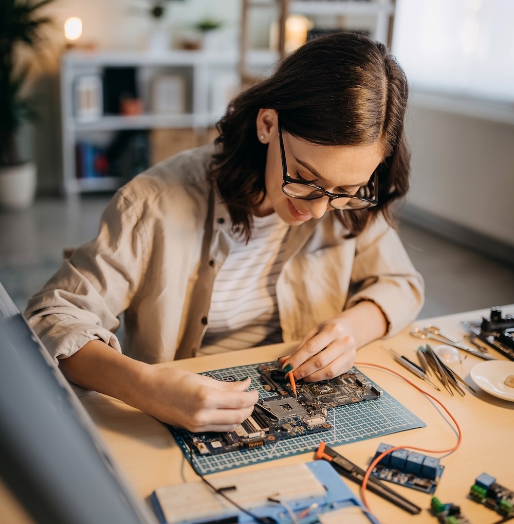 Female electrician at work on an electrical panel