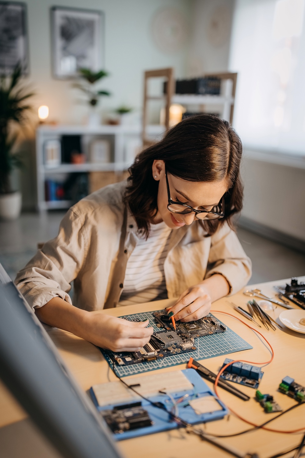 Female electrician at work on an electrical panel