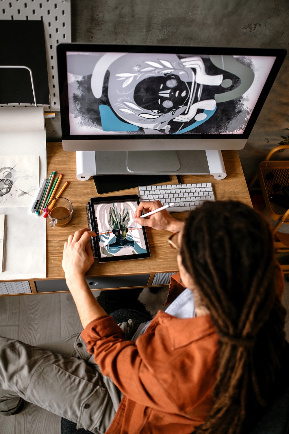 Creative graphic designer using digital tablet and computer, creating new design solutions