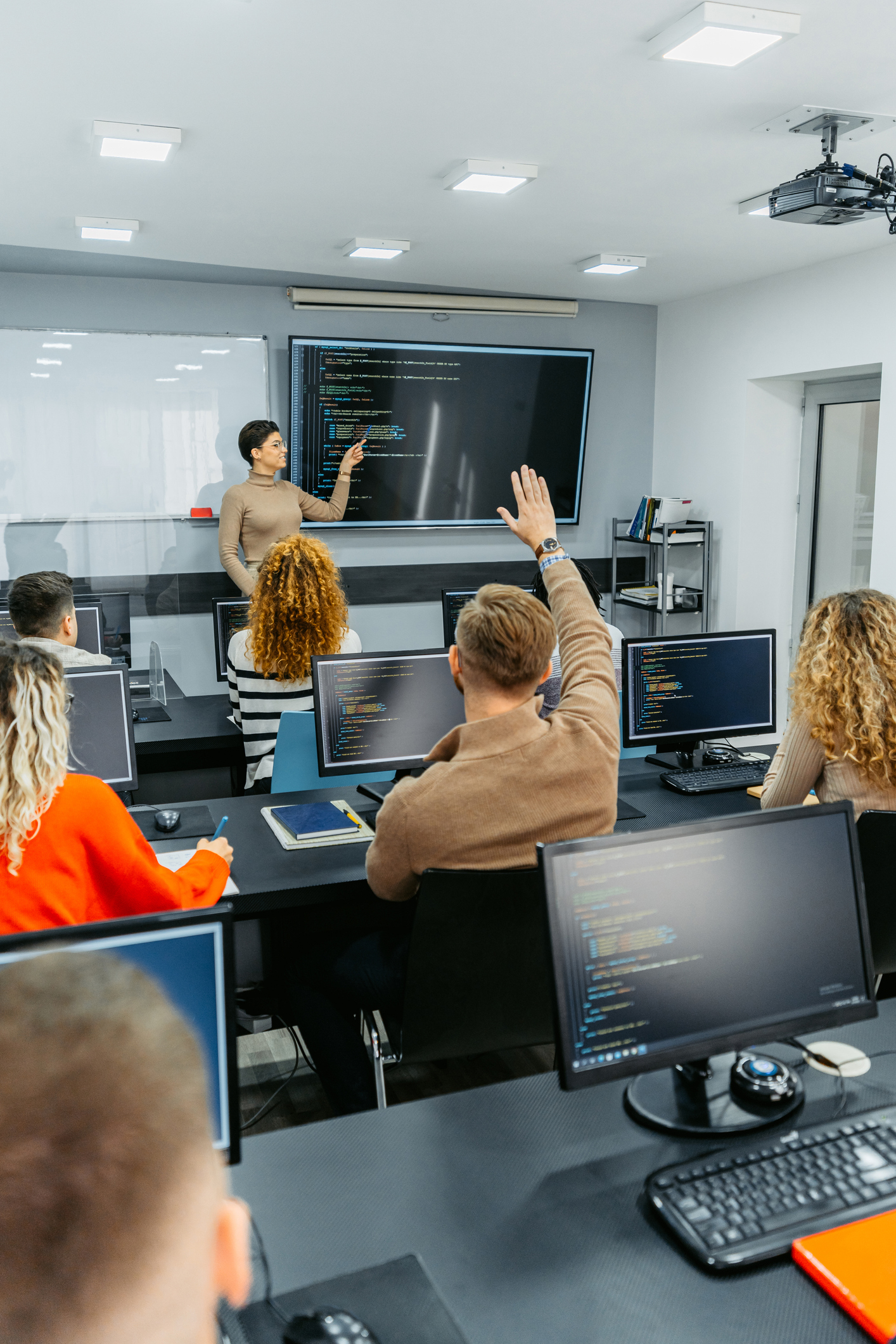 Young Female Teacher Teaching A Programing Class