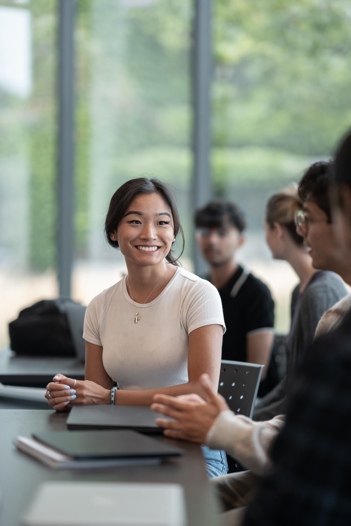 Young Woman Engaging in a Collaborative Discussion in a Bright Modern Setting