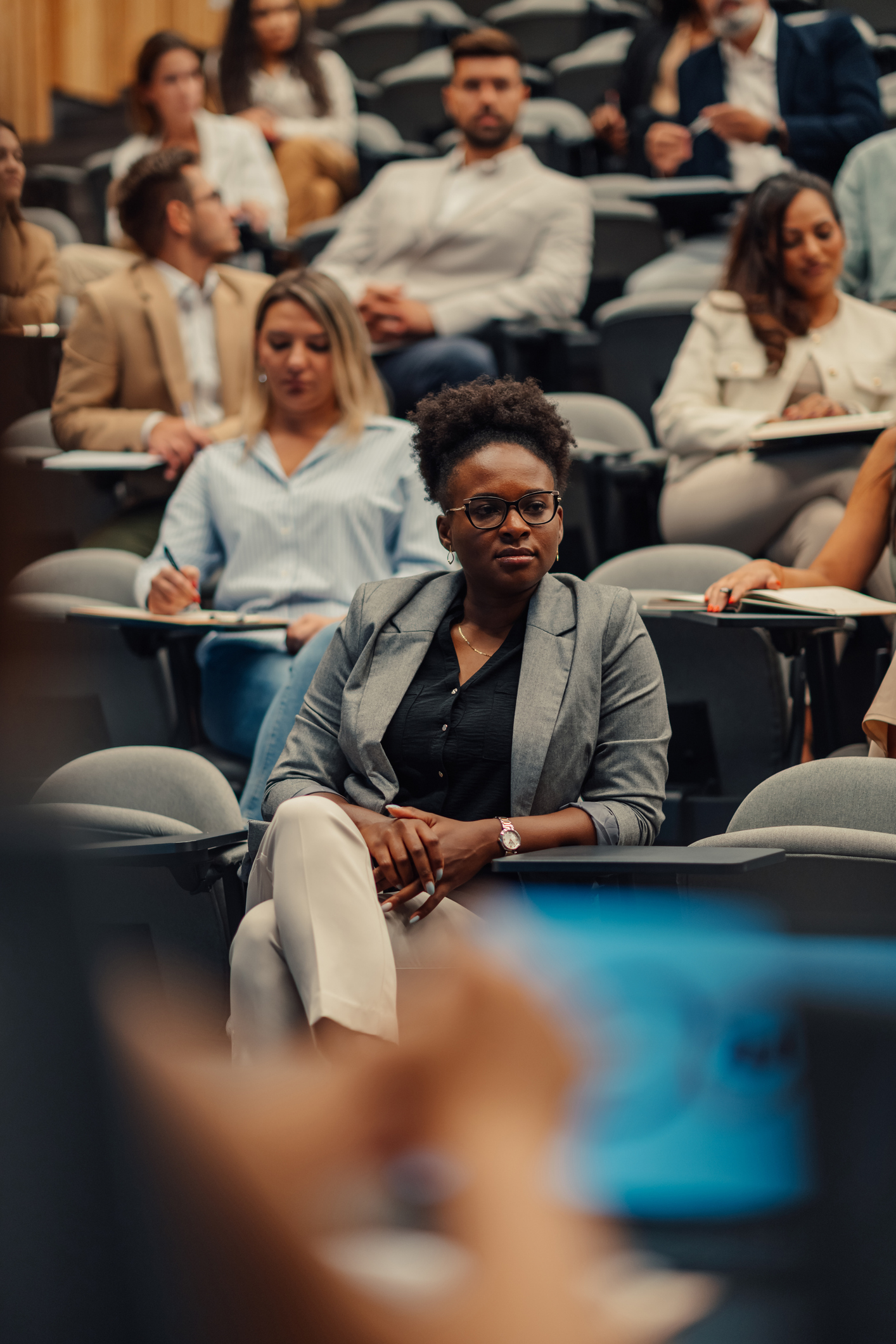 Professional adult woman listening during business seminar