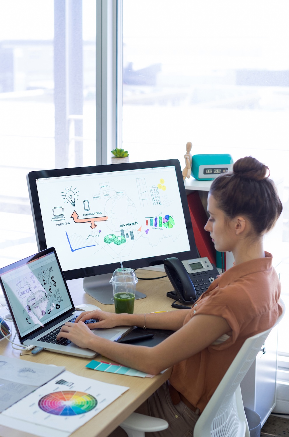Female executive working over laptop at her desk