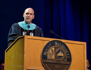 President Vander Hooven stands in front of a podium speaking.