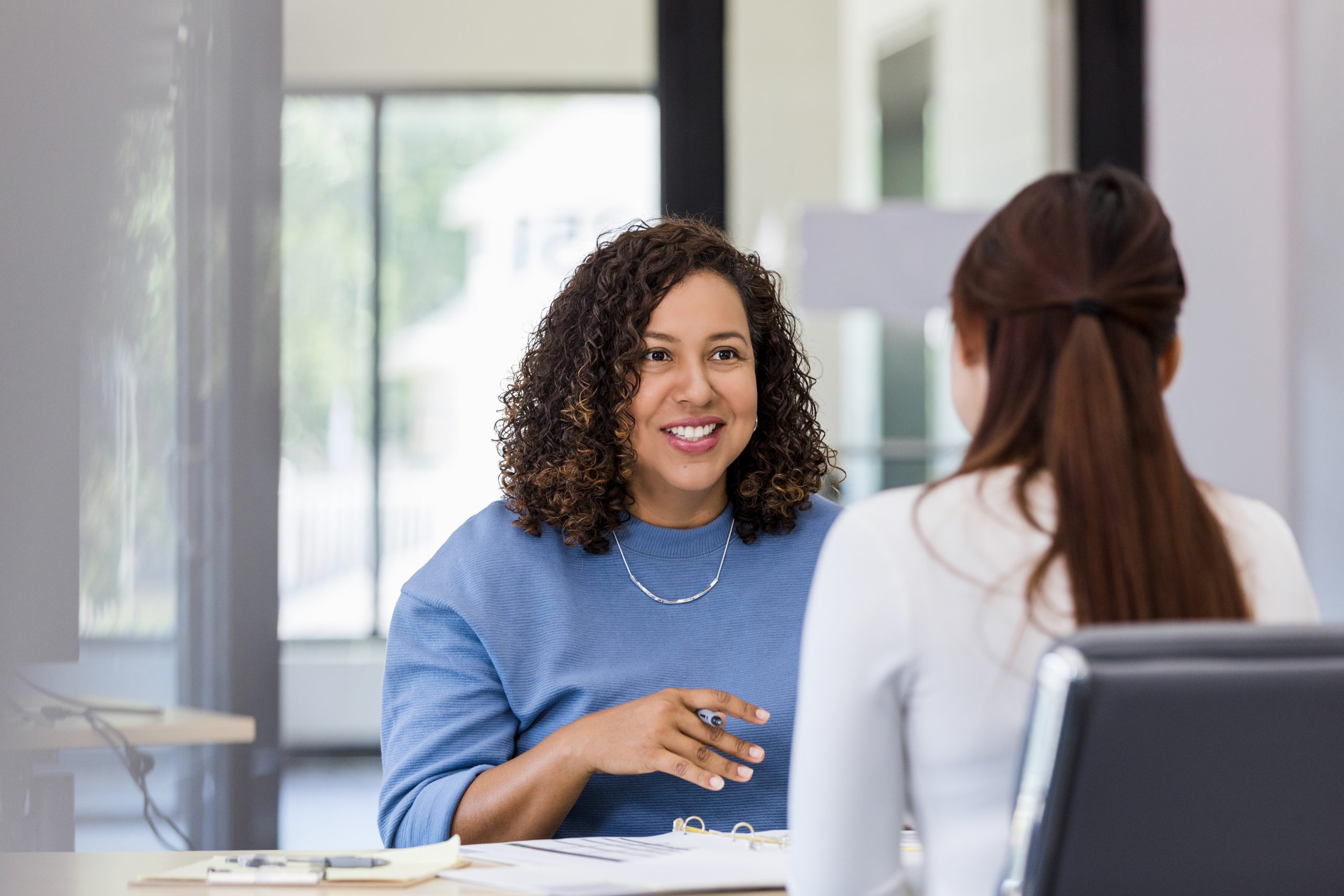 Female co-workers meet to discuss project