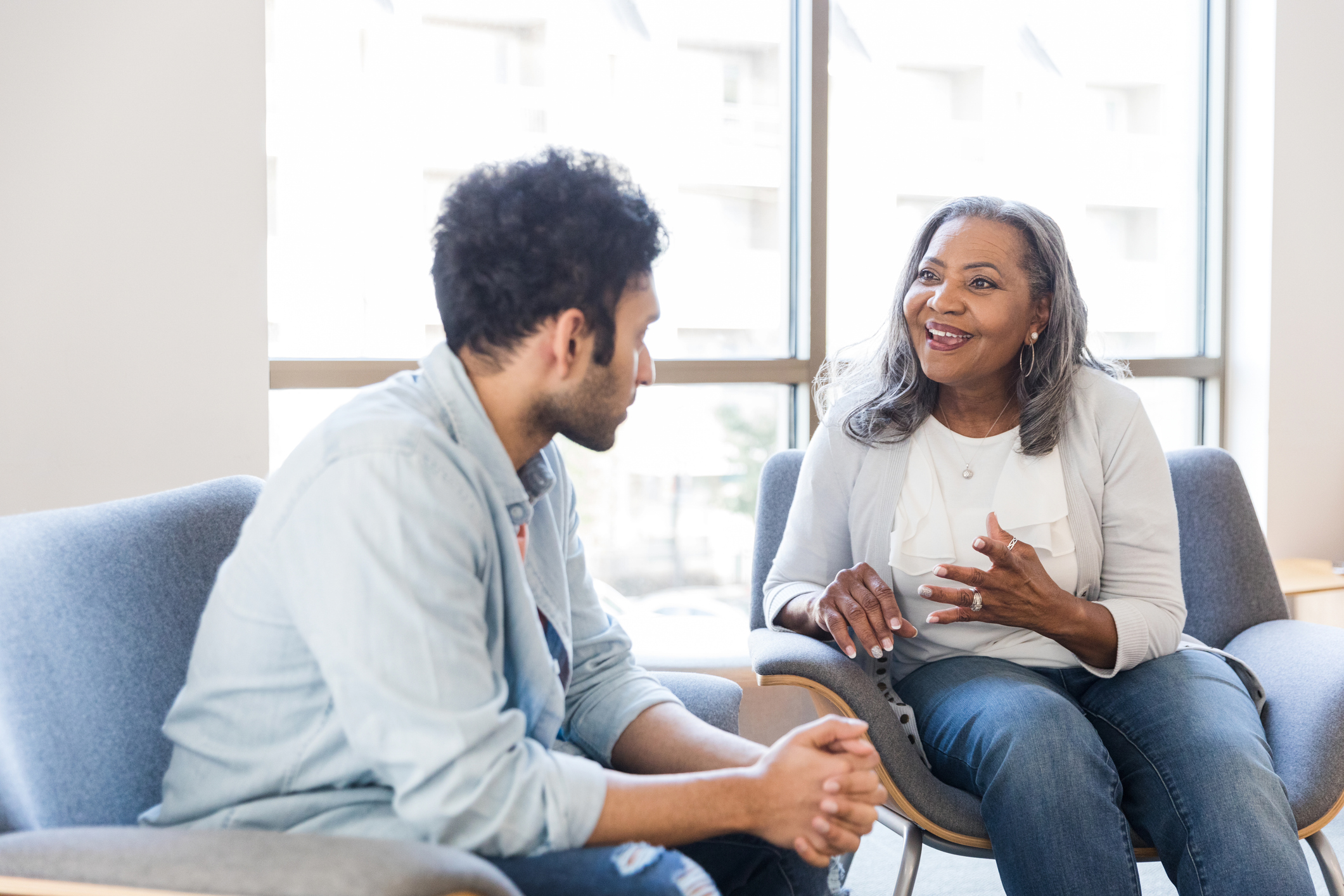 Senior female therapist is excited about young man’s progress