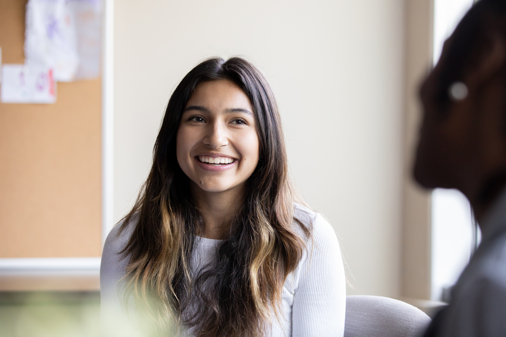 Teenage girl meets with school guidance counselor or therapist to discuss issues