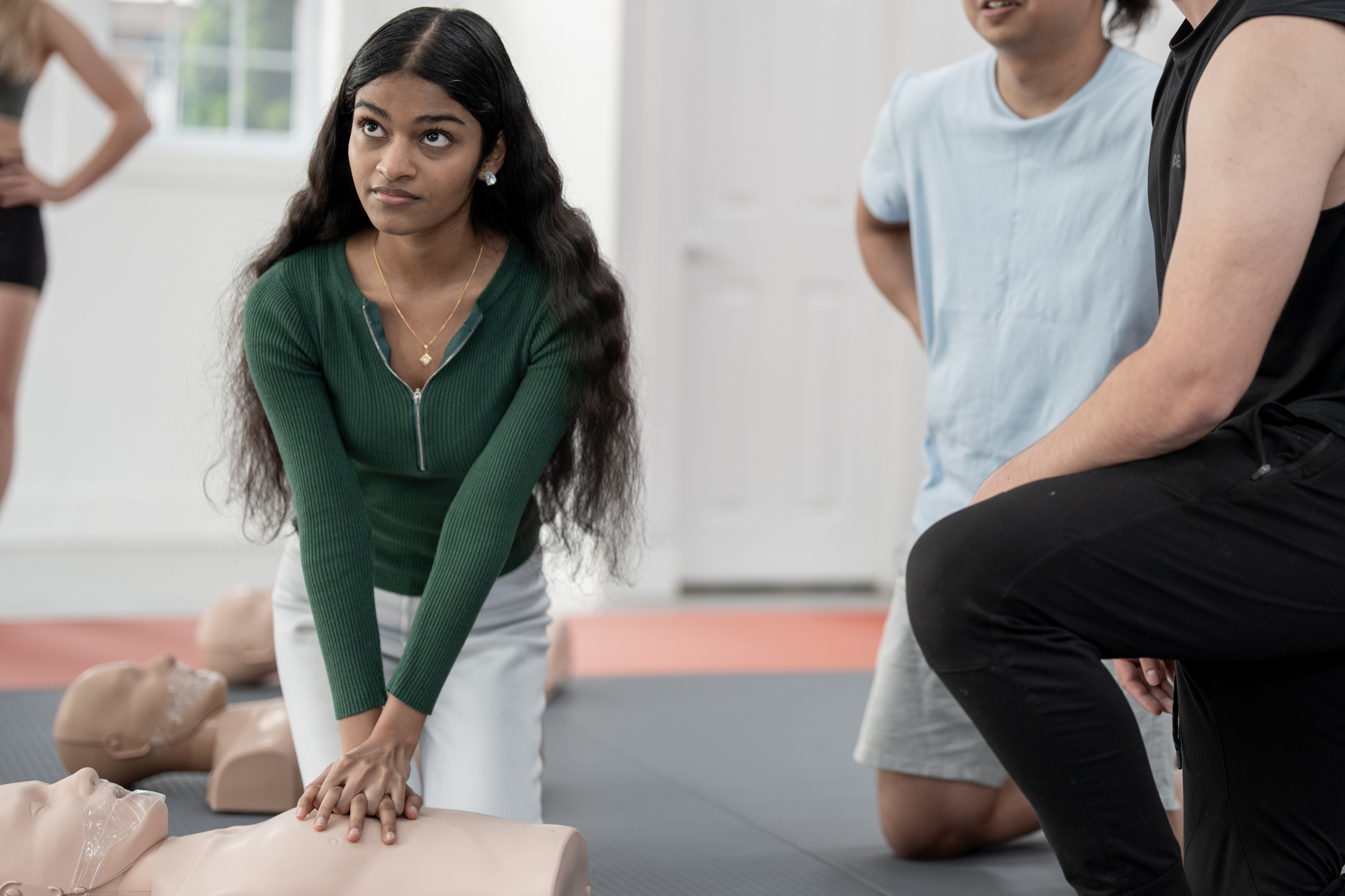 Young Adults Learning First Aid Techniques in a CPR Training Class