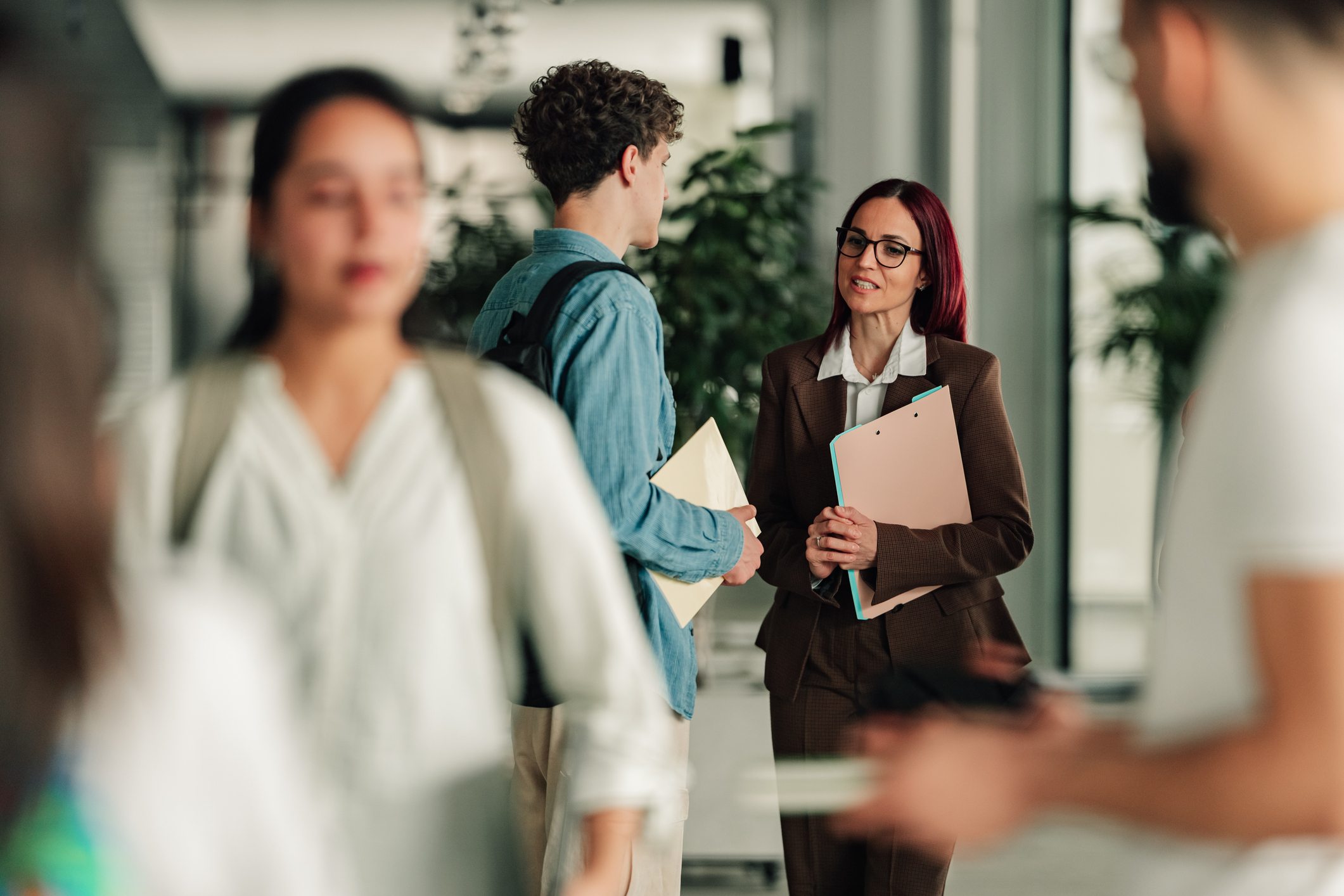 Students and professor interacting in a university setting, discussing academic topics and future education paths