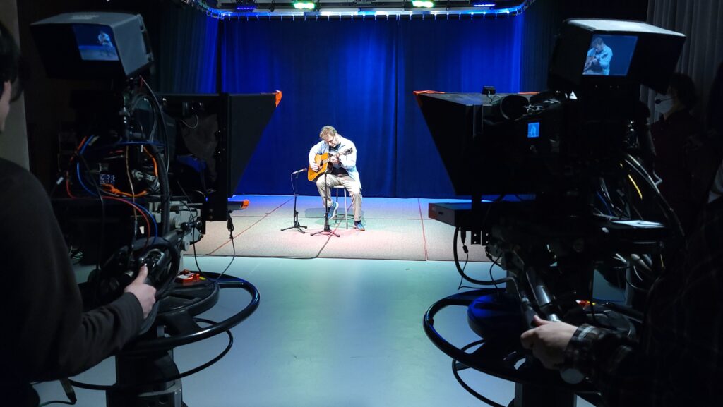 tv studio b with guitarist and cameras