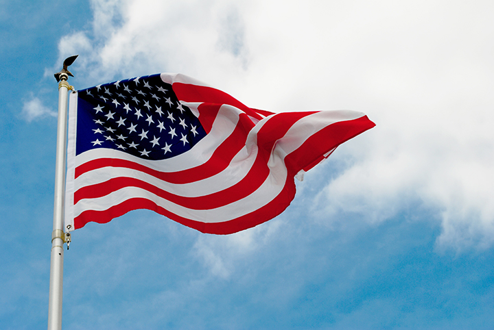 The,American,Flag,Flying,In,The,Wind,Filled,With,Pride.