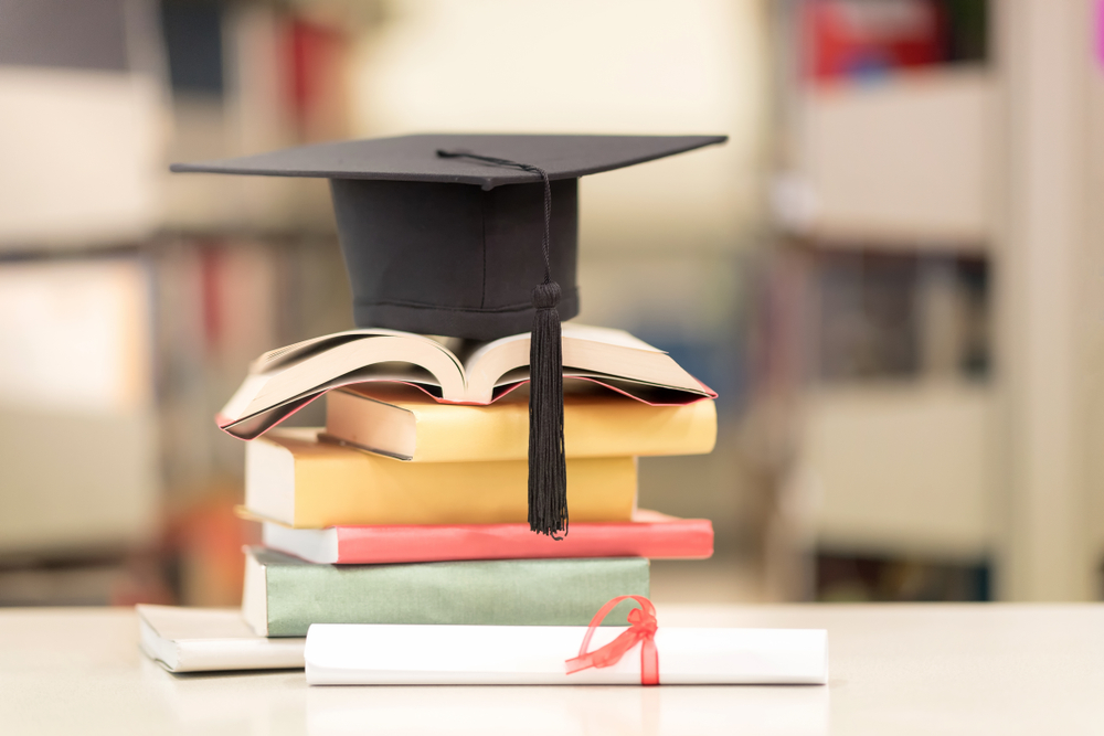 A,Certificate,And,A,Hat,On,Stack,Of,Book,Against