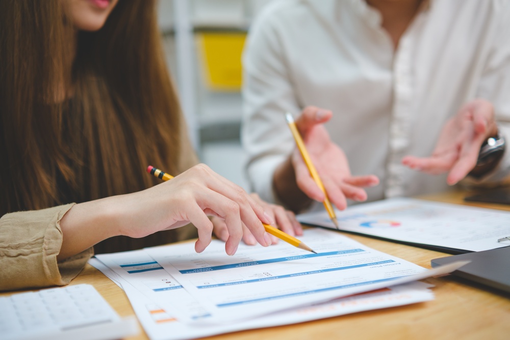Two,People,Analyzing,Financial,Data,Focusing,On,Performance,Results,Strategy