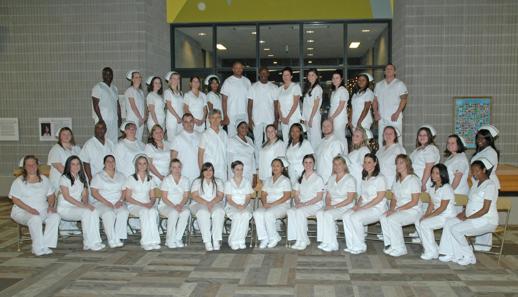 Formal group shot of the practical nursing class in their white uniforms