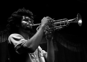 Black and white photo of Peter Shungu playing the trumpet