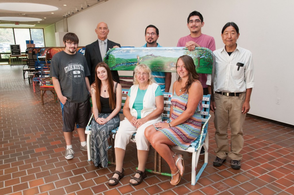 Group of art students with their painted ski chairs with Art Department profesor Tom Matsuda and President Dan Asquino