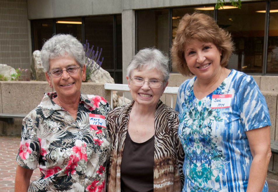 Three nursing alumni posing for a photo outside the Gardner campus