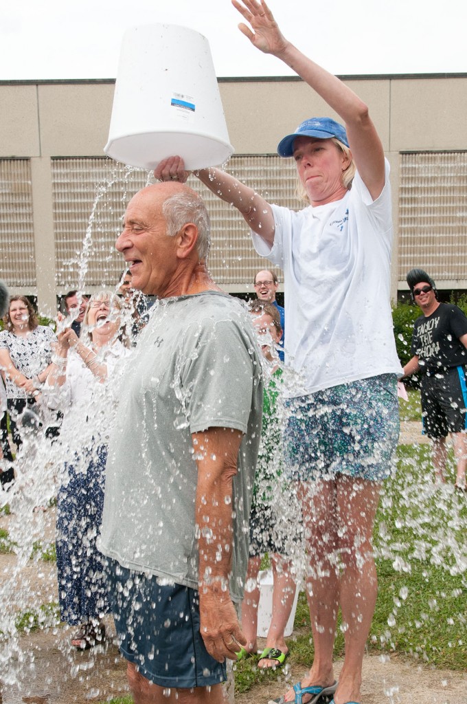 Ann McDonald pouring a bucket of ice water of President Dan Asquino's head