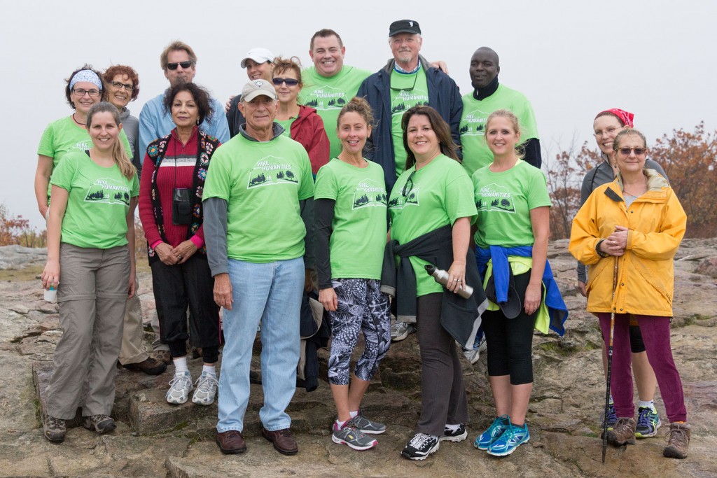 Group of faculty, staff, students and community members at the top of Mount Wachusett