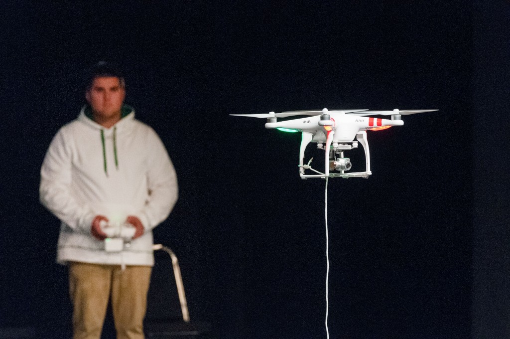 Mount Wachusett Community College pre-engineering student Casey Bortle pilots the college’s new drone during a Math Modeling Initiative presentation to 350 area high school seniors.