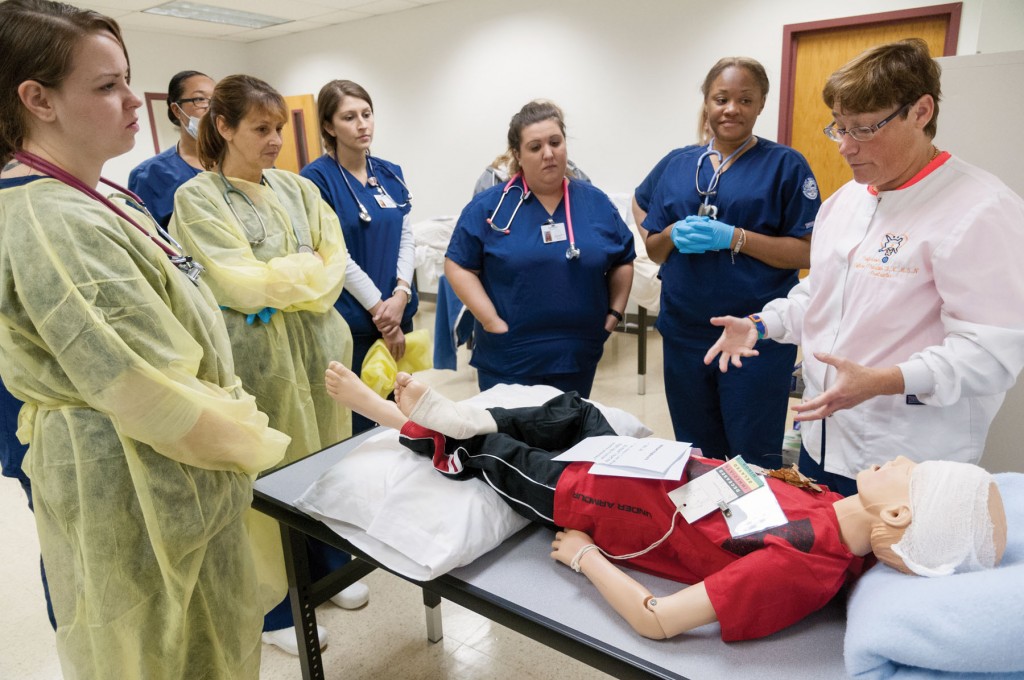 Associate Professor of Nursing Collene Thaxton briefs practical nursing students following the completion of disaster training at MWCC's Devens campus.