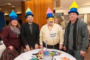 “The Trivial Pursuits” team, four members with Trivial Pursuit pieces on their hats