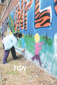 Student painting a mural