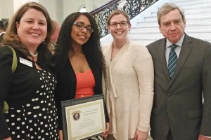 Bella Ballin holding her scholarship certificate with Lea Ann Scales, Natalie Mercier and Richard Freeland