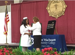 Fortunate Munhutu on stage receiving her pin from Dean Eileen Costello