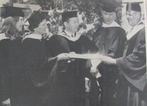 Historical black and white photo of MWCC graduates with President Haley