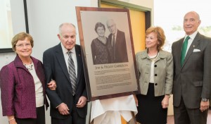 James and Peggy Garrison and Tina Sbrega and President Asquino standing with the plaque that will be installed in the Garrison center